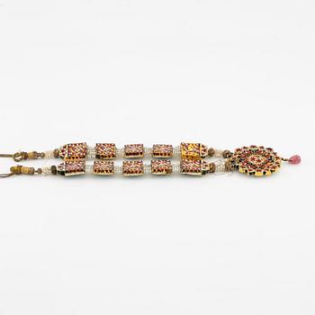 An antique gold and enamel Qajar necklace with pearls set with turquoises and with a garnet drop.