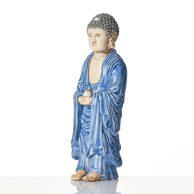 A porcelain figure of a standing Buddha, Qing dynasty, 18th Century.