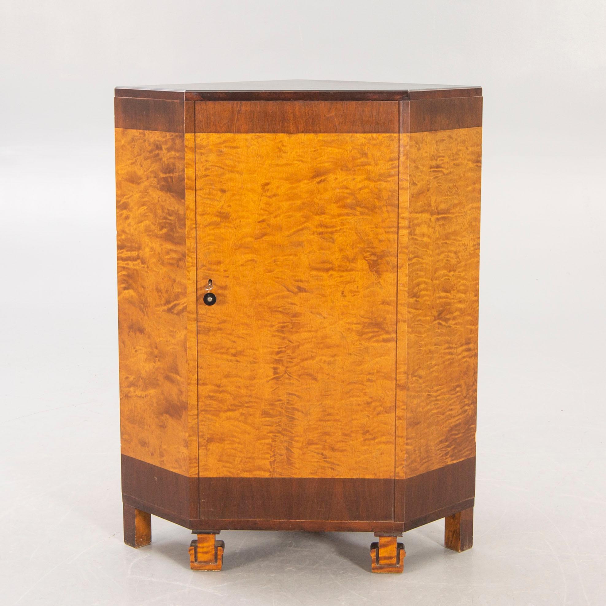 A 1930s birch corner cabinet.