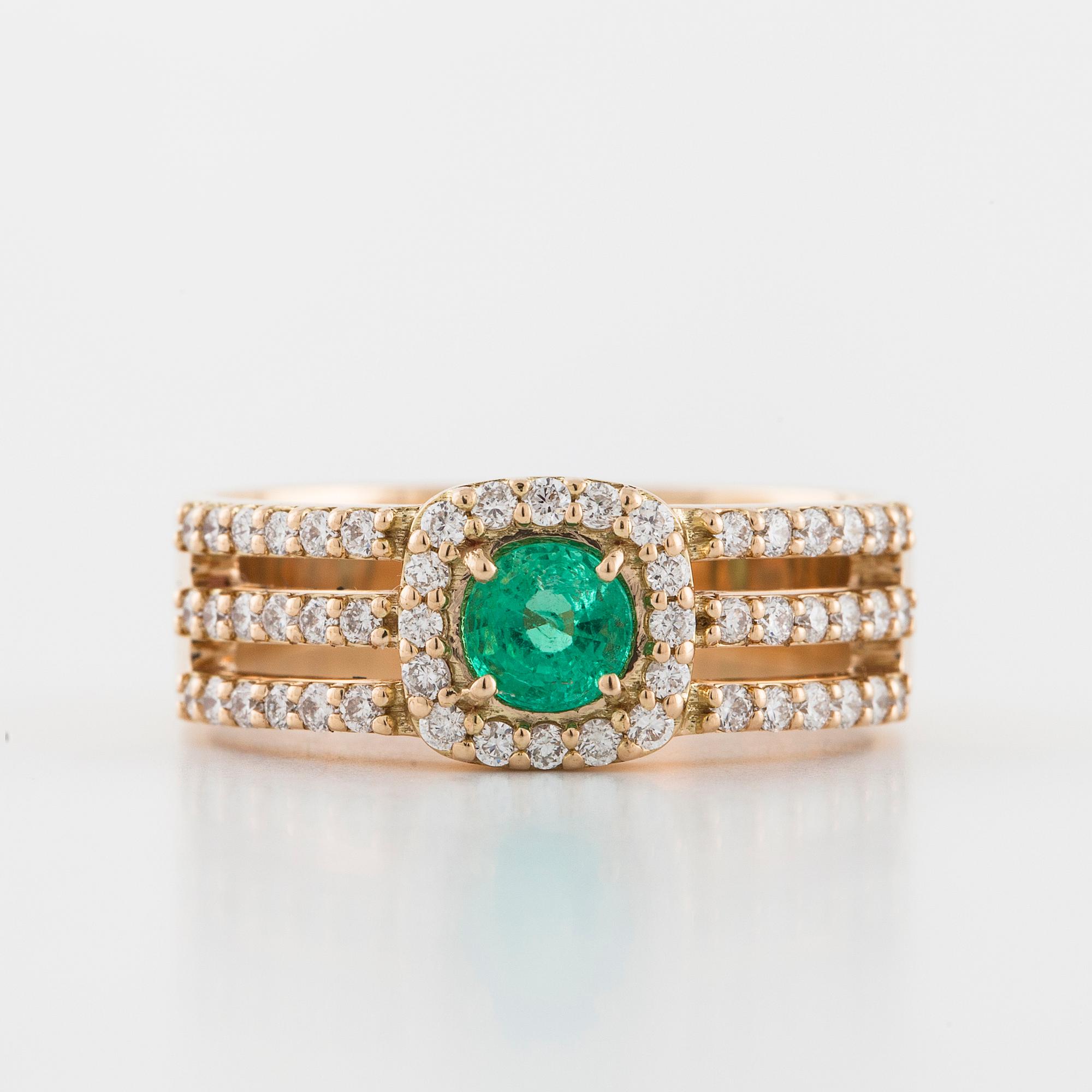 A faceted emerald and brilliant cut diamond ring.
