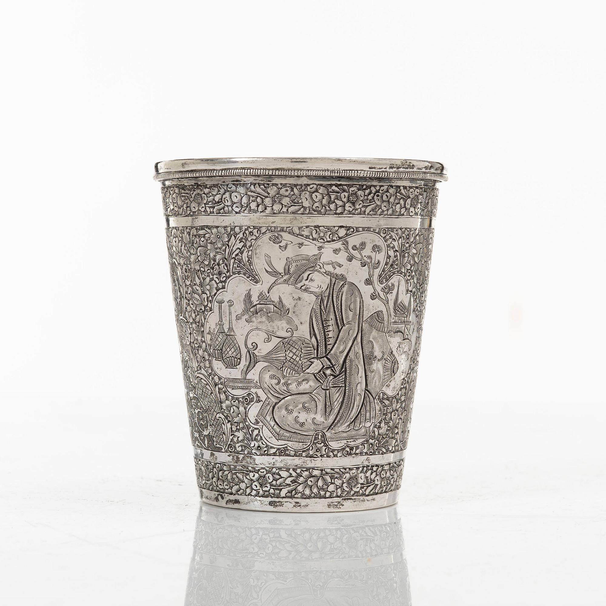 A Persian silver pitcher with five stemmed cups and a beaker, first part of the 1900s.