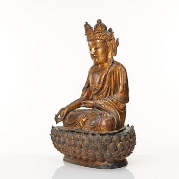 A large cold gilt sculpture of a crowned medicine Buddha/Bhaisjyaguru, Ming dynasty (1368-1644).