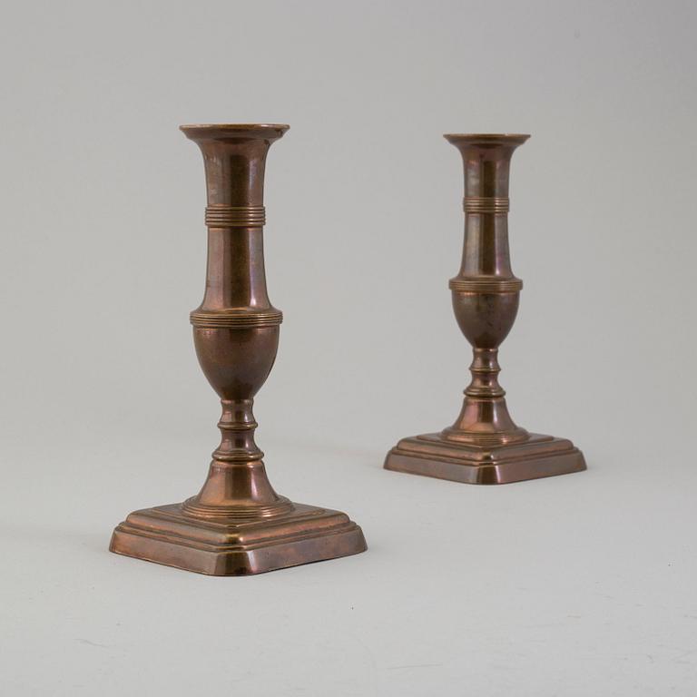 A pair of 19th century bronze candlesticks.