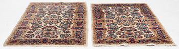 A pair of similar Kirman rugs, south Persia, c. 147 x 94 and 154 x 96 cm.