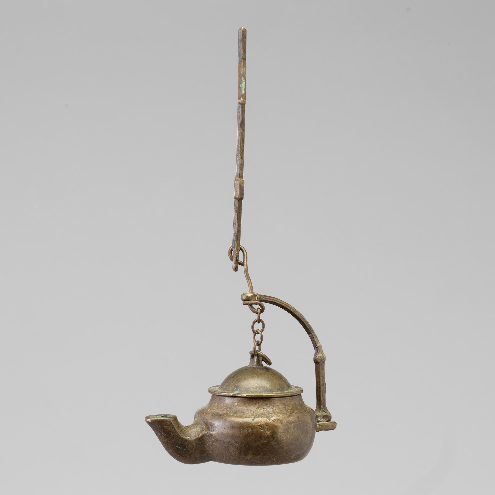 A 18th century oil lamp.