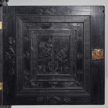 A Louis XIV and Louis XIV-style carved ebony, ivory and tortoiseshell-inlaid cabinet on stand, 17th and 19th century.