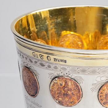 A Swedish Gustavian silver parcel-gilt beaker with cover and copper coins, mark of F Petersson Ström, Stockholm 1789.