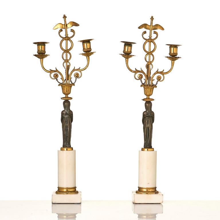 A pair of late Gustavian white marble and bronze candelabra.