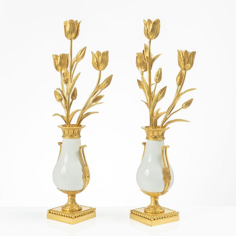 A pair of three light porcelain and gilt bronze three-branch Louis XV-style candelabra, mid 19th century.