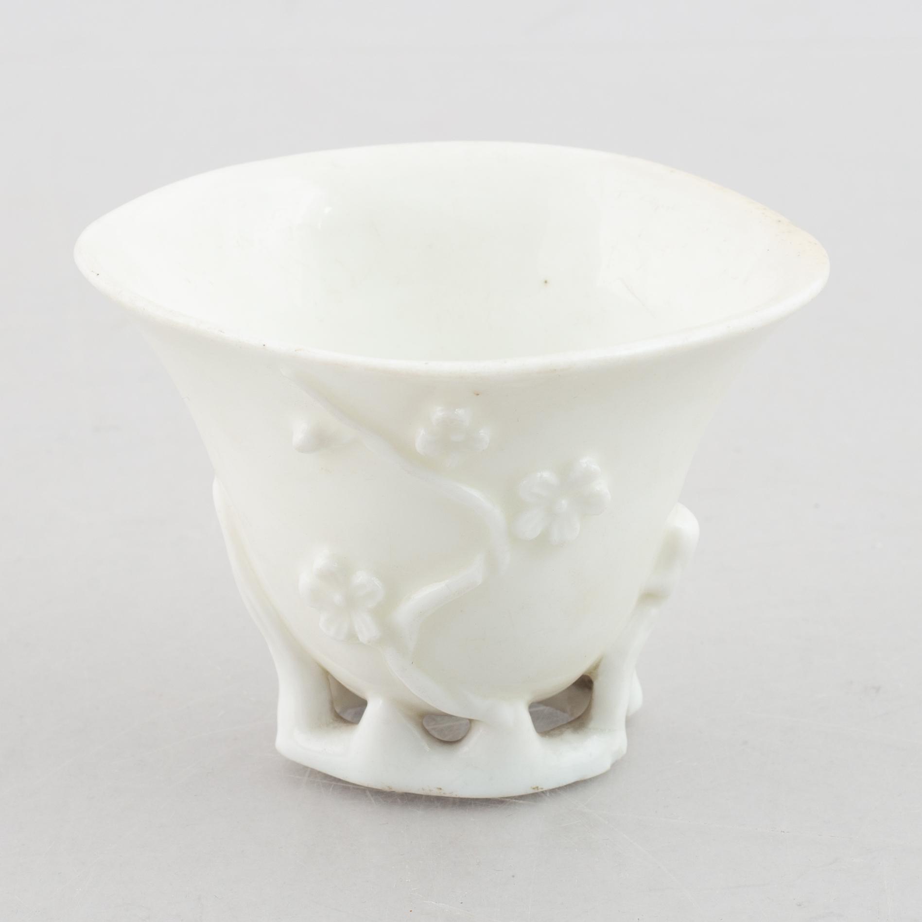 A blanc de chine rhinoceros libation cup, Qing dynasty, 18th century.