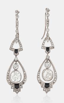 1127. A pair of old-cut diamond and onyx earrings. Total carat weight circa 4.70 cts.