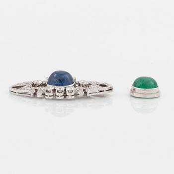 A platinum brooch set with a cabochon-cut sapphire and a cabochon-cut emerald.