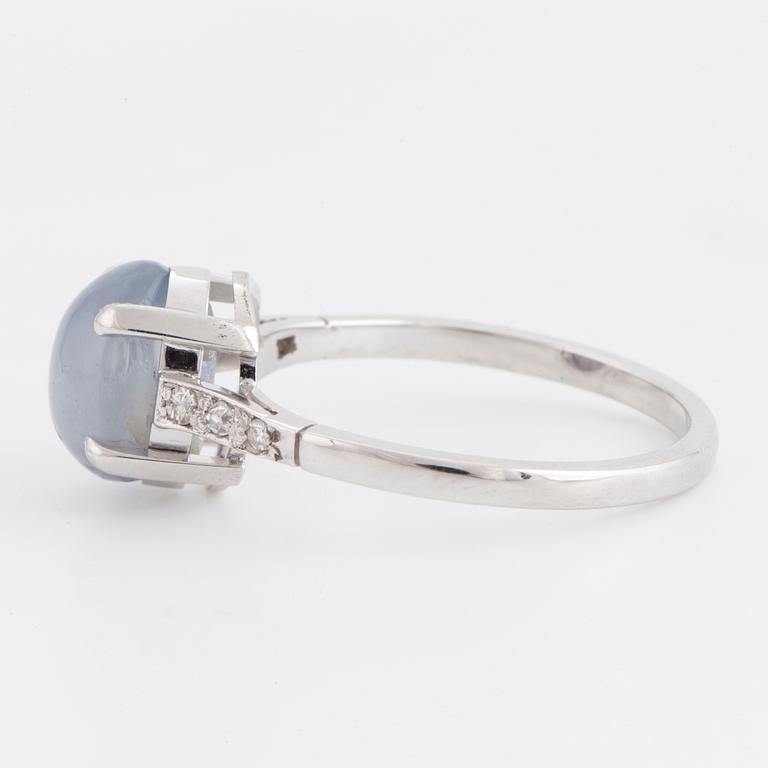 A cabochon-cut star sapphire and diamond ring.