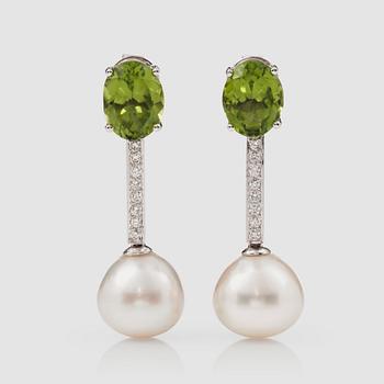 1121. A pair of peridot, 
brilliant-cut diamond and cultured South sea pearl earrings.