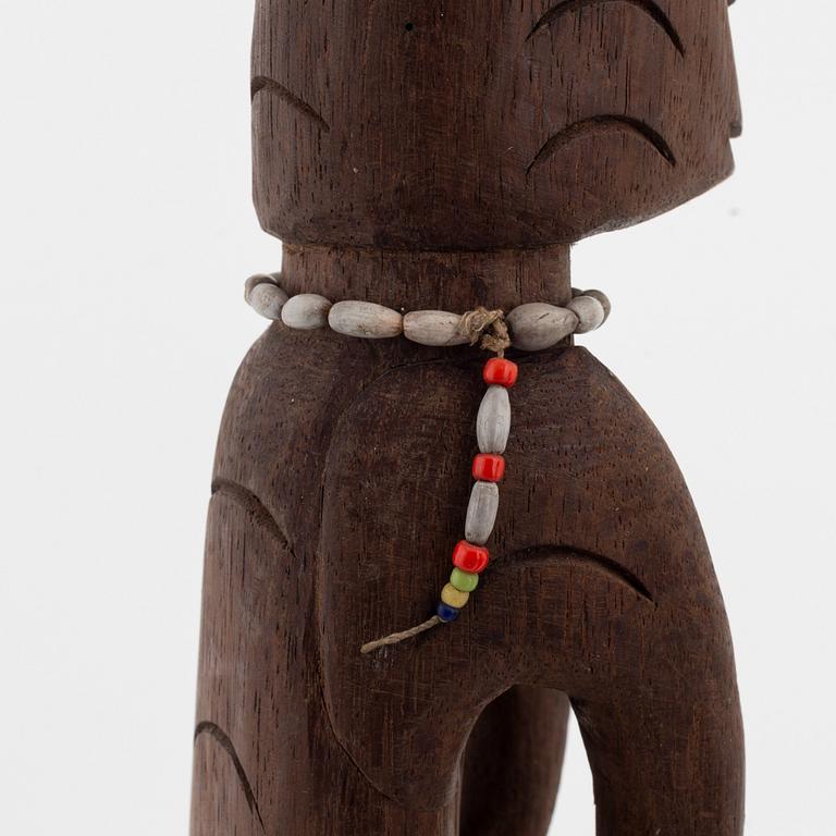 A group of three wooden Asmat sculptures, 20th Century.