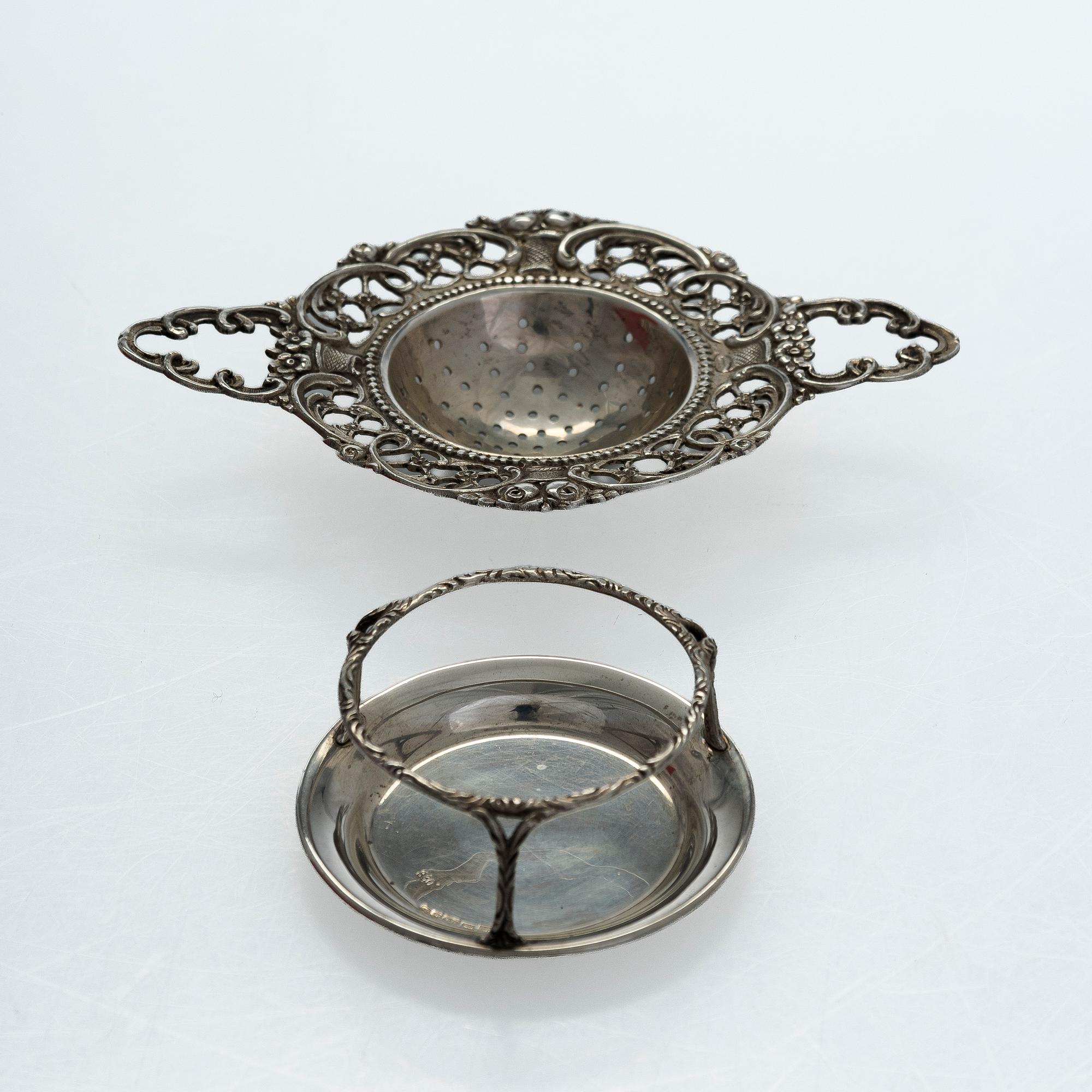 A pair of Russian silver salt cellars, a sprinkle spoon, a sauce ladle, and a tea strainer, Finnish marks.