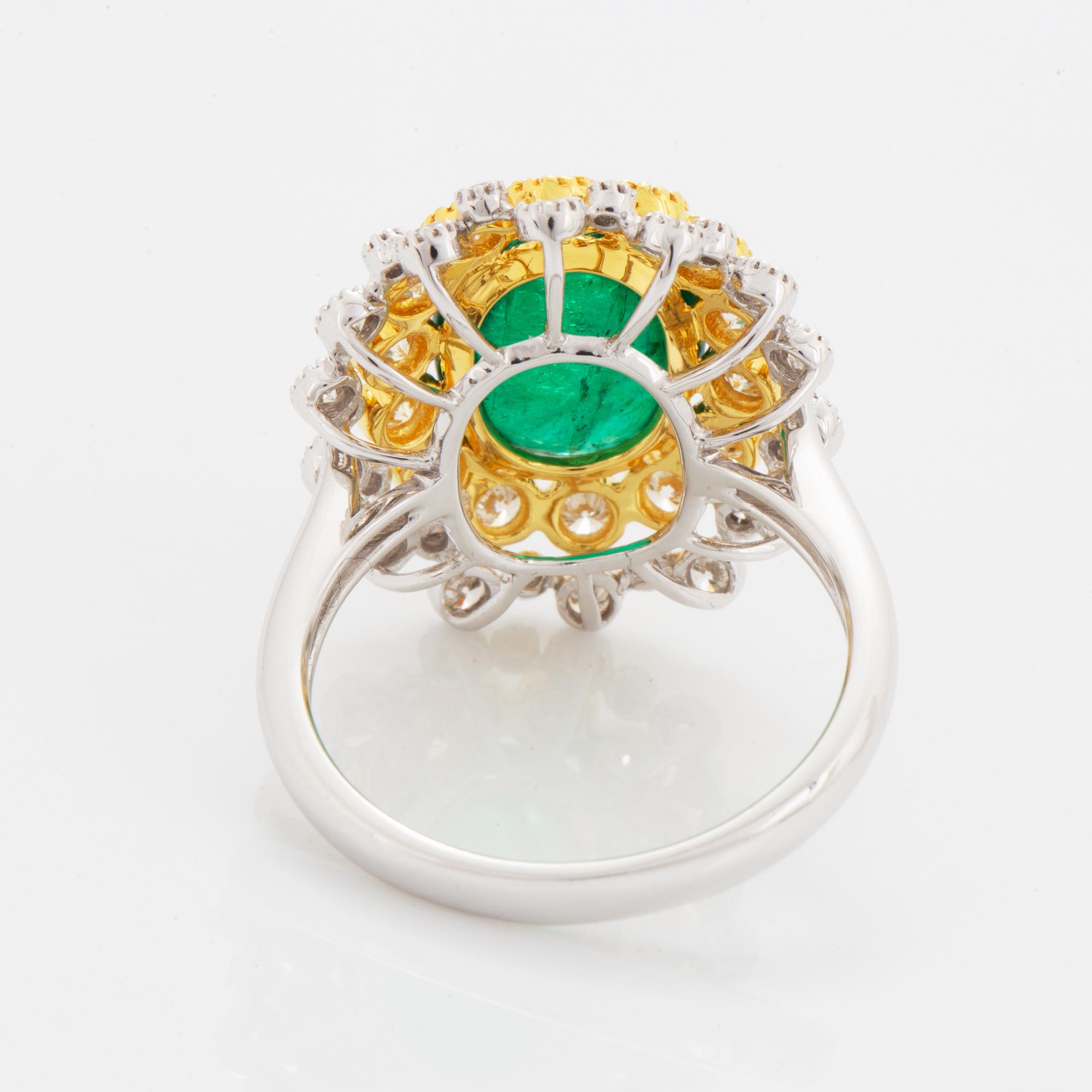 Cabochon-cut emerald and brilliant-cut diamond ring.
