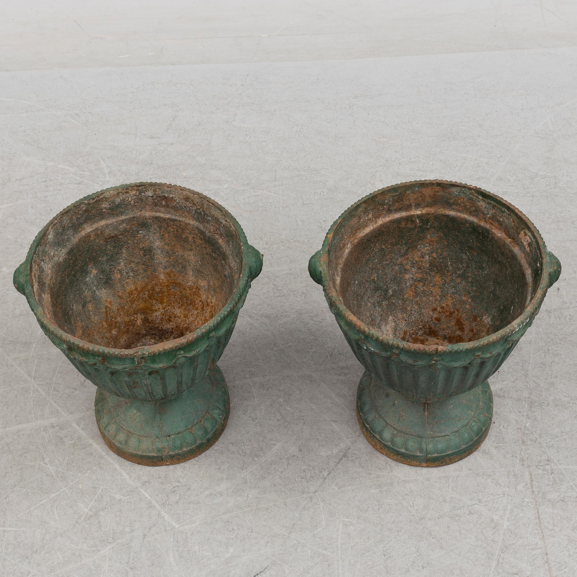 A pair of early 20th century iron garden urns.