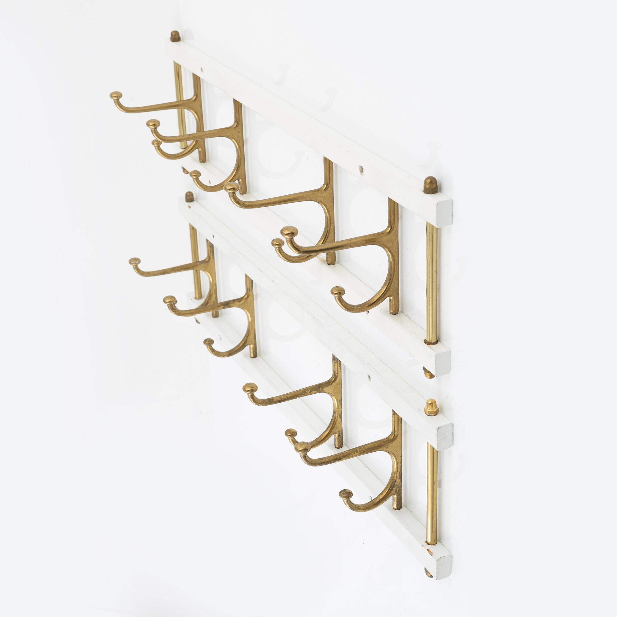 A pair of 'Dekorativ' coat hangers, Skoglunds metallgjuteri, Anderstorp, mid 20th Century.