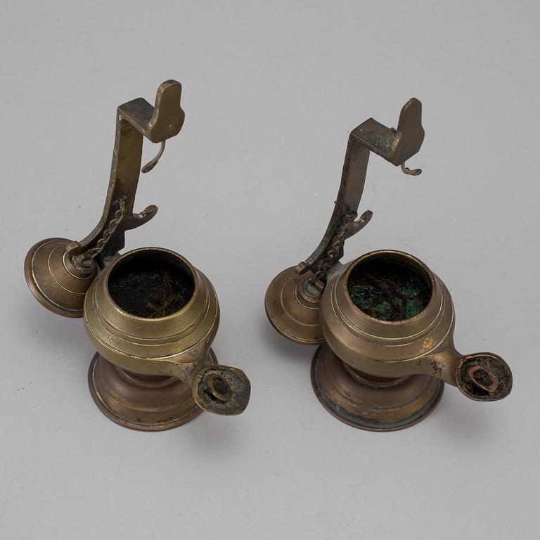 A pair of 17th/18th century bronze oil lamps.