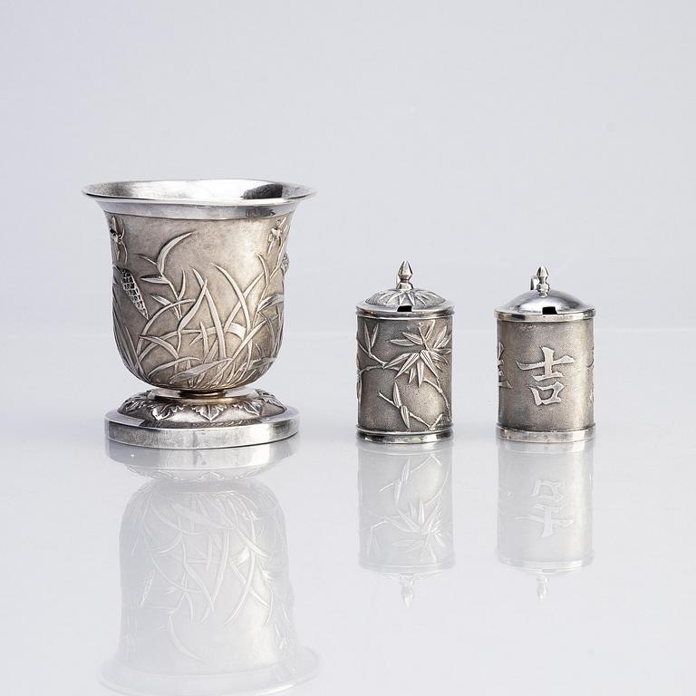 A Chinese Export silver beaker and two silver mustard pots, early 20th century.