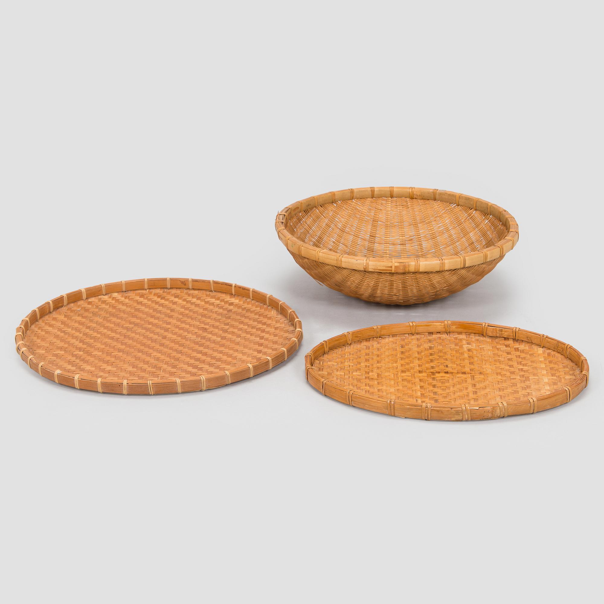 A mid-20th century rattan basket and two rattan trays. Retailer Artek Finland.