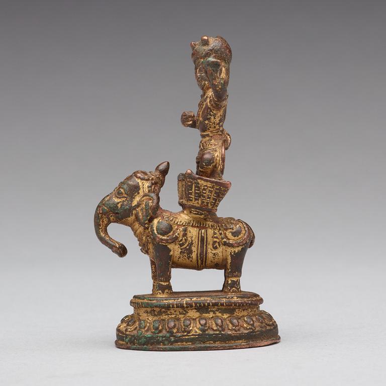 A gilt bronze figure of a deity on an elephant, presumably Nepal, 15th Century.