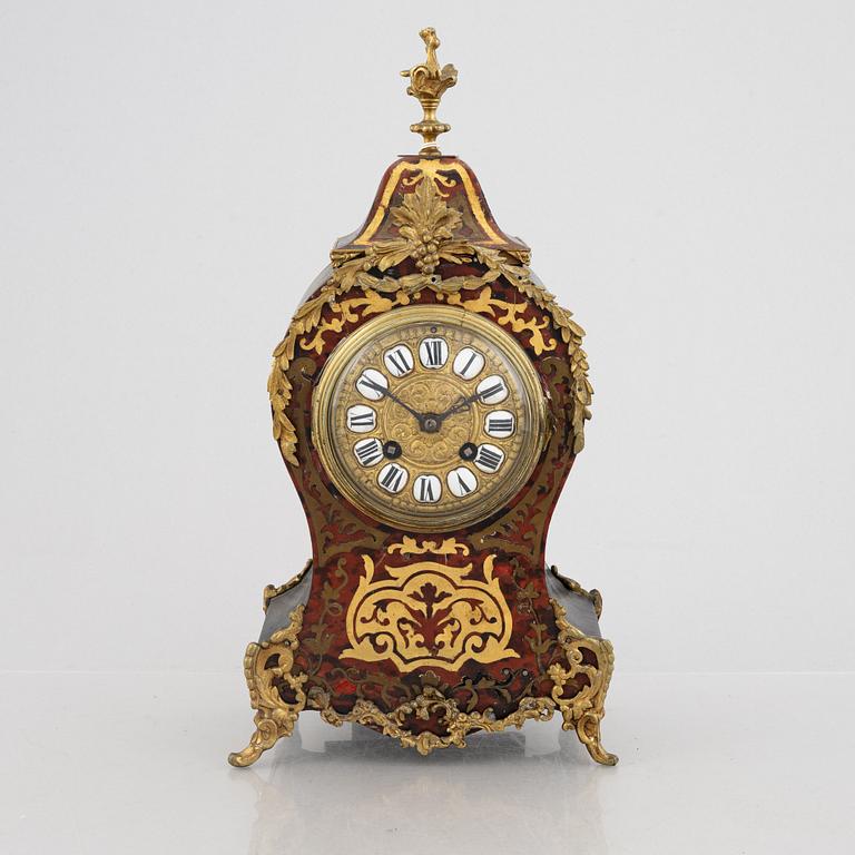 A Louis XV-style mantel clock, late 19th century.