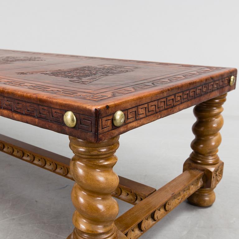 A Peruvian leather covered coffee table and pair of stools, second half of the 20th Century.