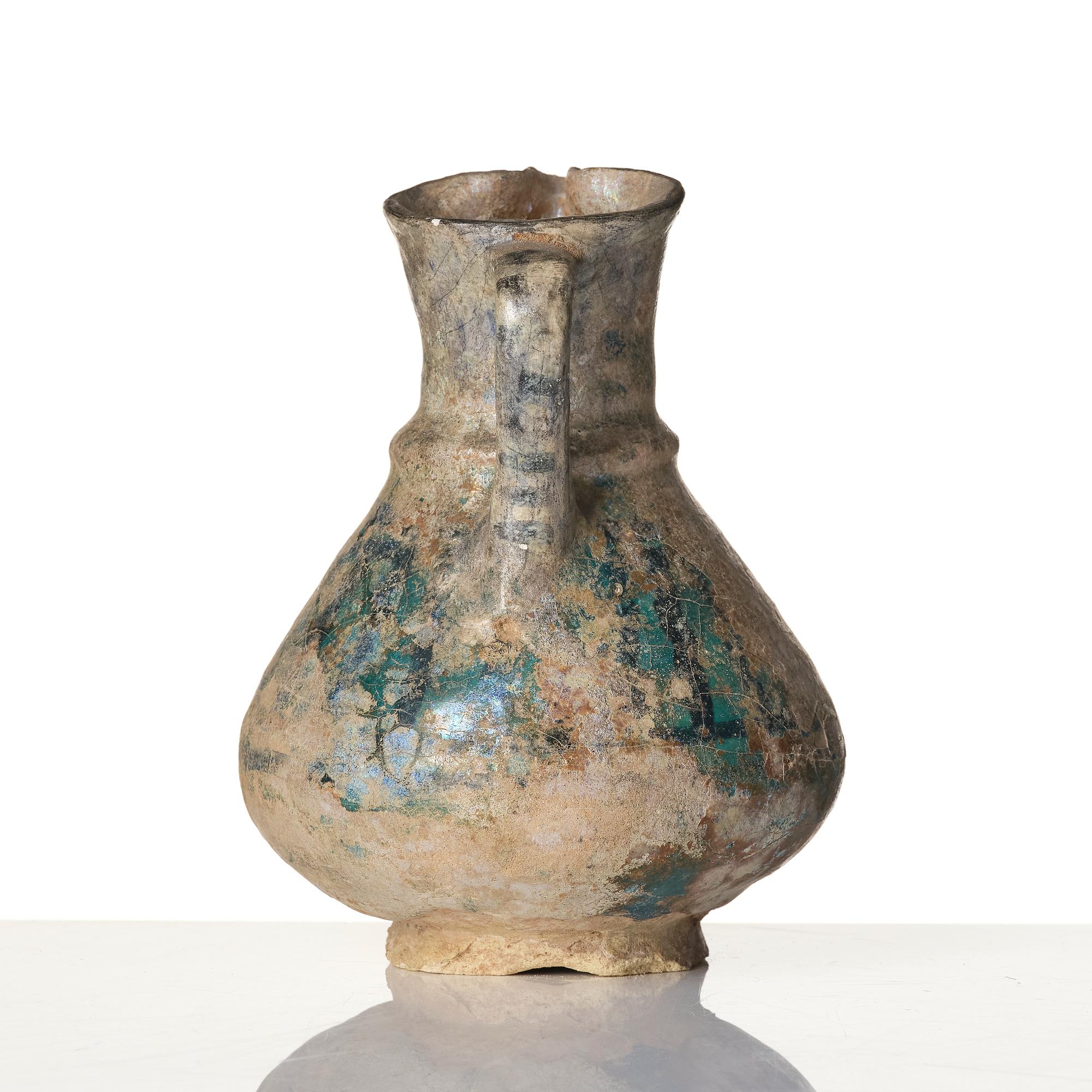 A turquoise-glazed Keshan jug, Persian, 13th century.