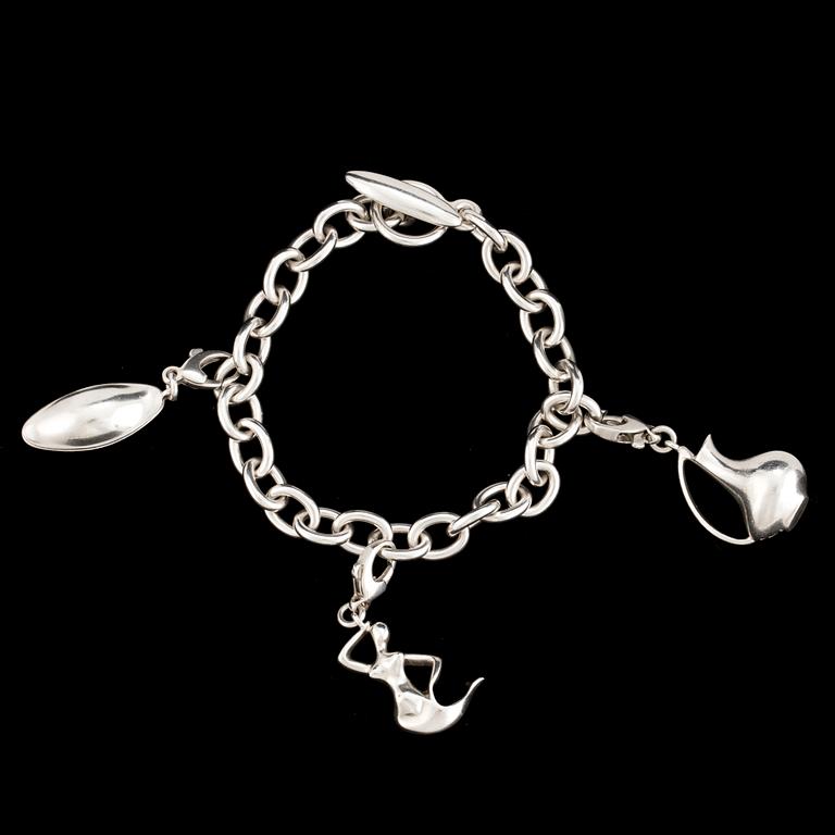 A silver bracelet and three charms by Georg Jensen, after 1945.