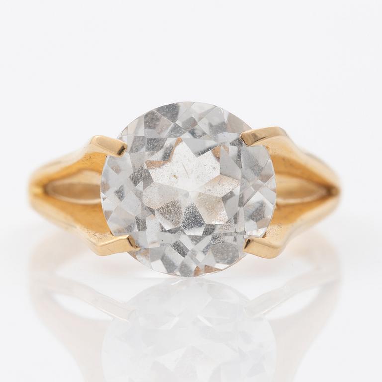 Ring, 18K gold with a synthetic white stone.