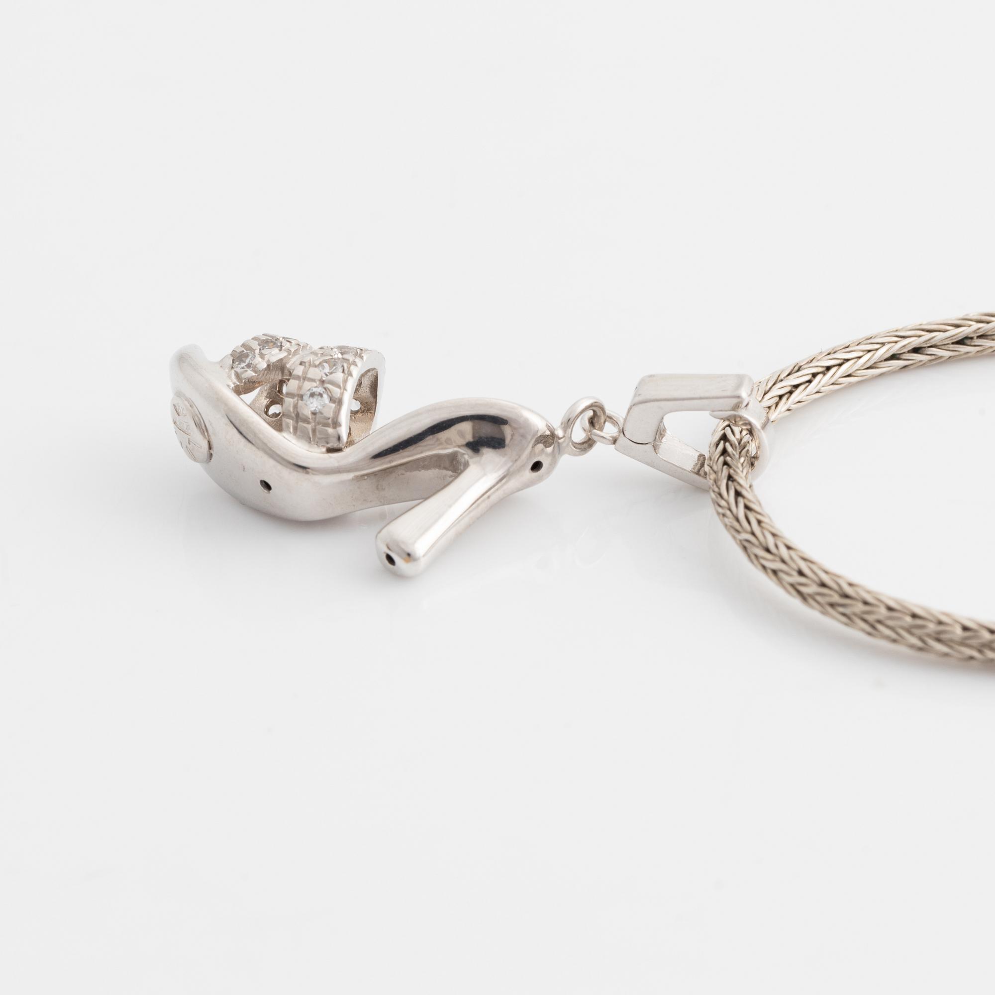 18K white gold shoe pendant with faceted white stones, silver chain.