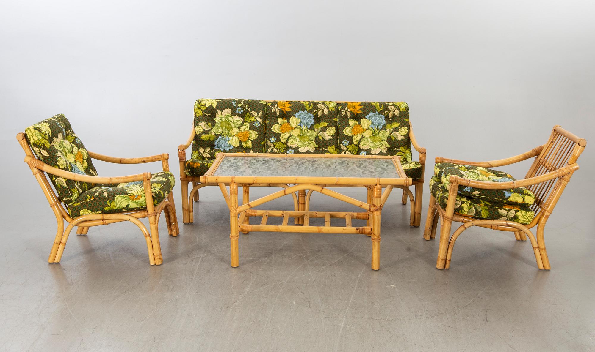 A set of ratten furniture, late 20th century; sofa, armchairs and a lounge table.