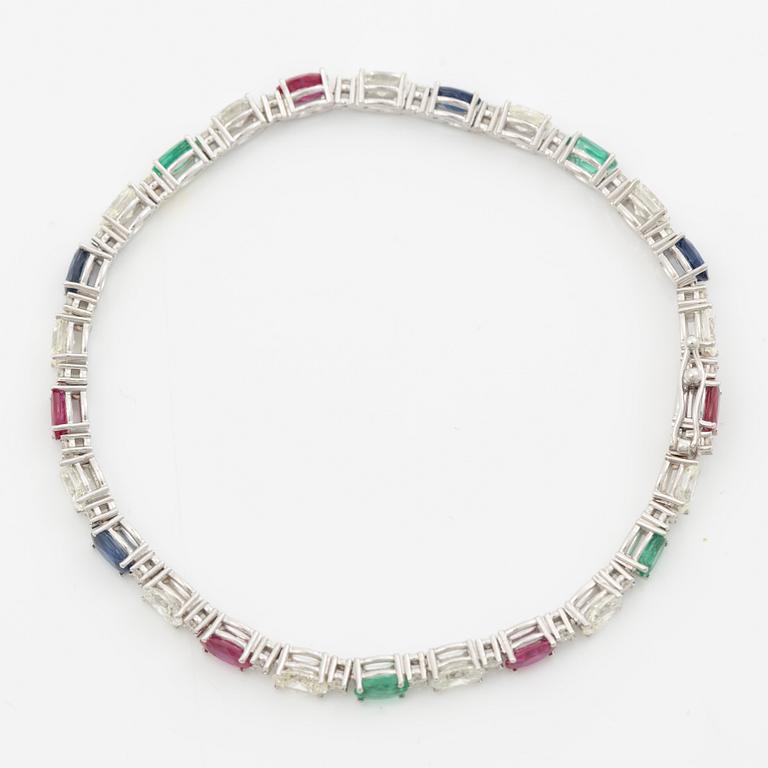 Bracelet 18K white gold set with faceted rubies, emeralds, sapphires, and round brilliant-cut diamonds.