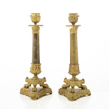 A pair of brass and bronze late Empire candle sticks, mid 20th century.