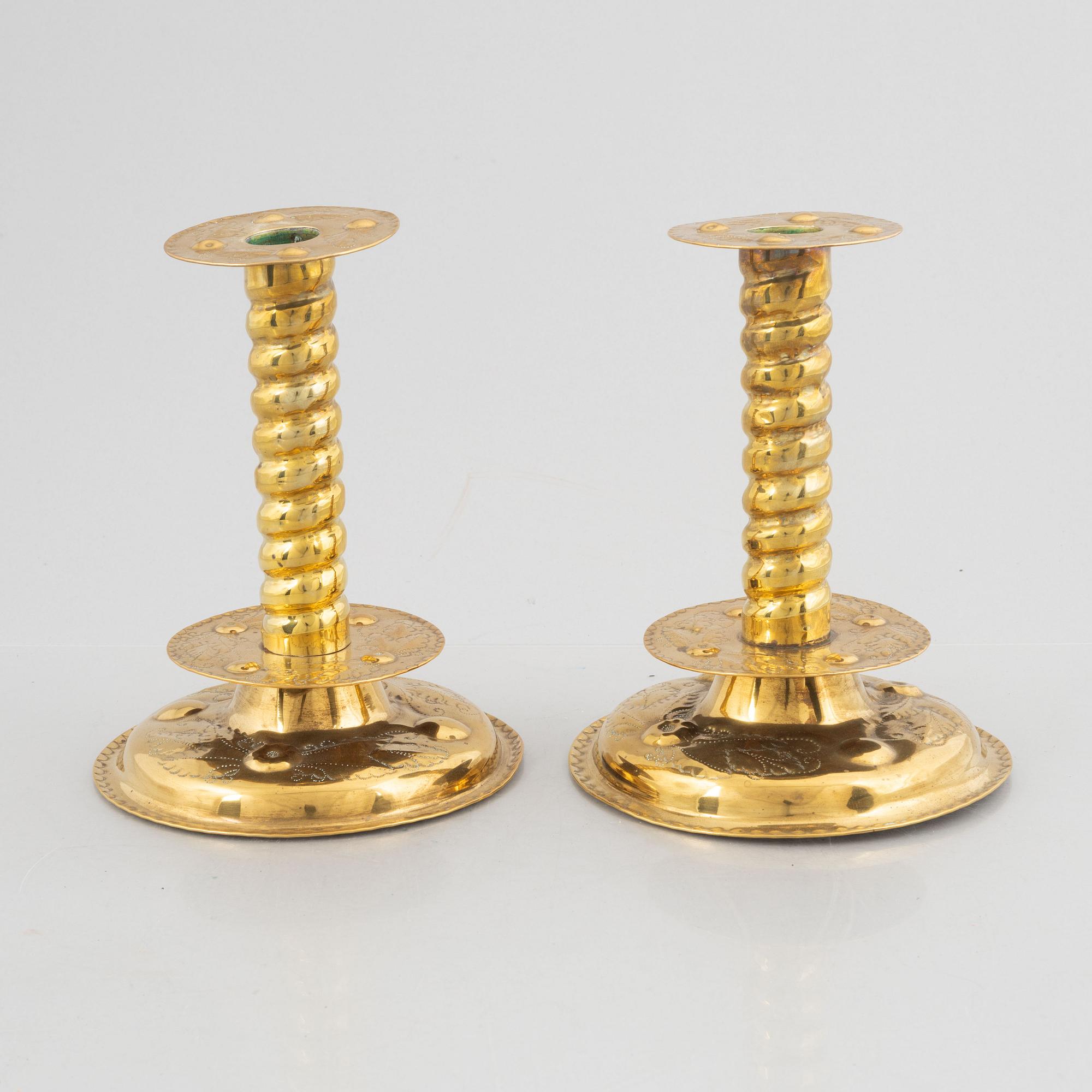 A pair of brass baroque style candlesticks, end of the 19th century.