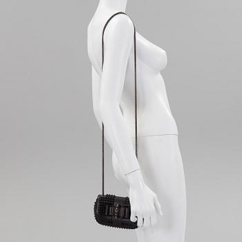 An eveningbag with studs by Christian Louboutin.