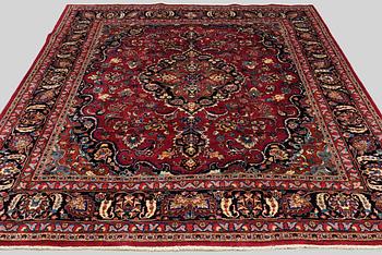 A carpet Mashad, signed, around 290 x 245 cm.