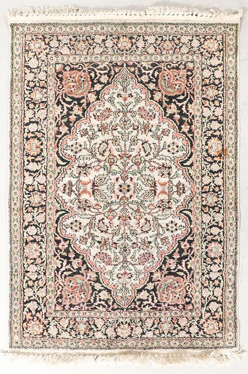 An oriental silk carpet ca 140x87 cm.