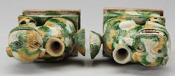 A pair of green and yellow glazed bisquit cencers, in the shape of sitting Buddhist lions, Qing Dynasty, Kangxi (1662-1722).