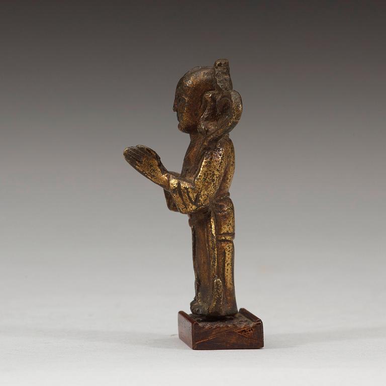A gilt bronze figure of a standing boy, Ming dynasty, 15th/16th century.