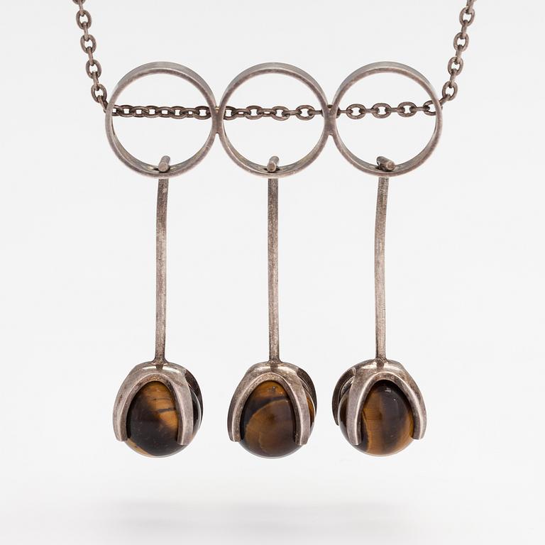 Elis Kauppi, A silver necklace with tiger's eye pearls. Kupittaan kulta, Turku 1965.