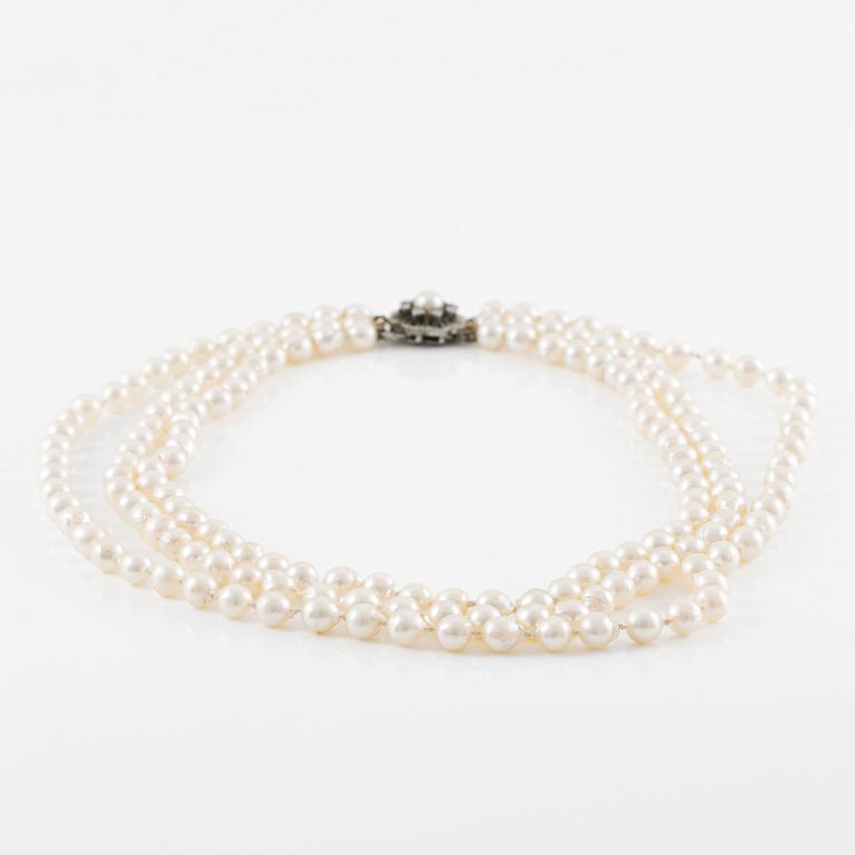 Necklace, three strands of cultured pearls, clasp in silver set with brilliant-cut diamonds.