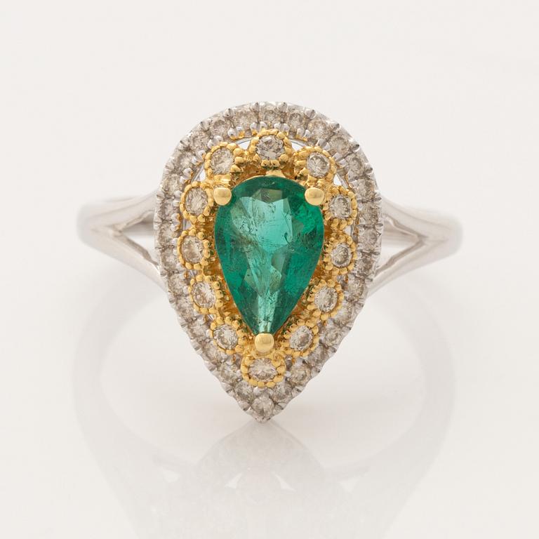 Pear shaped emerald and brilliant cut diamond ring.