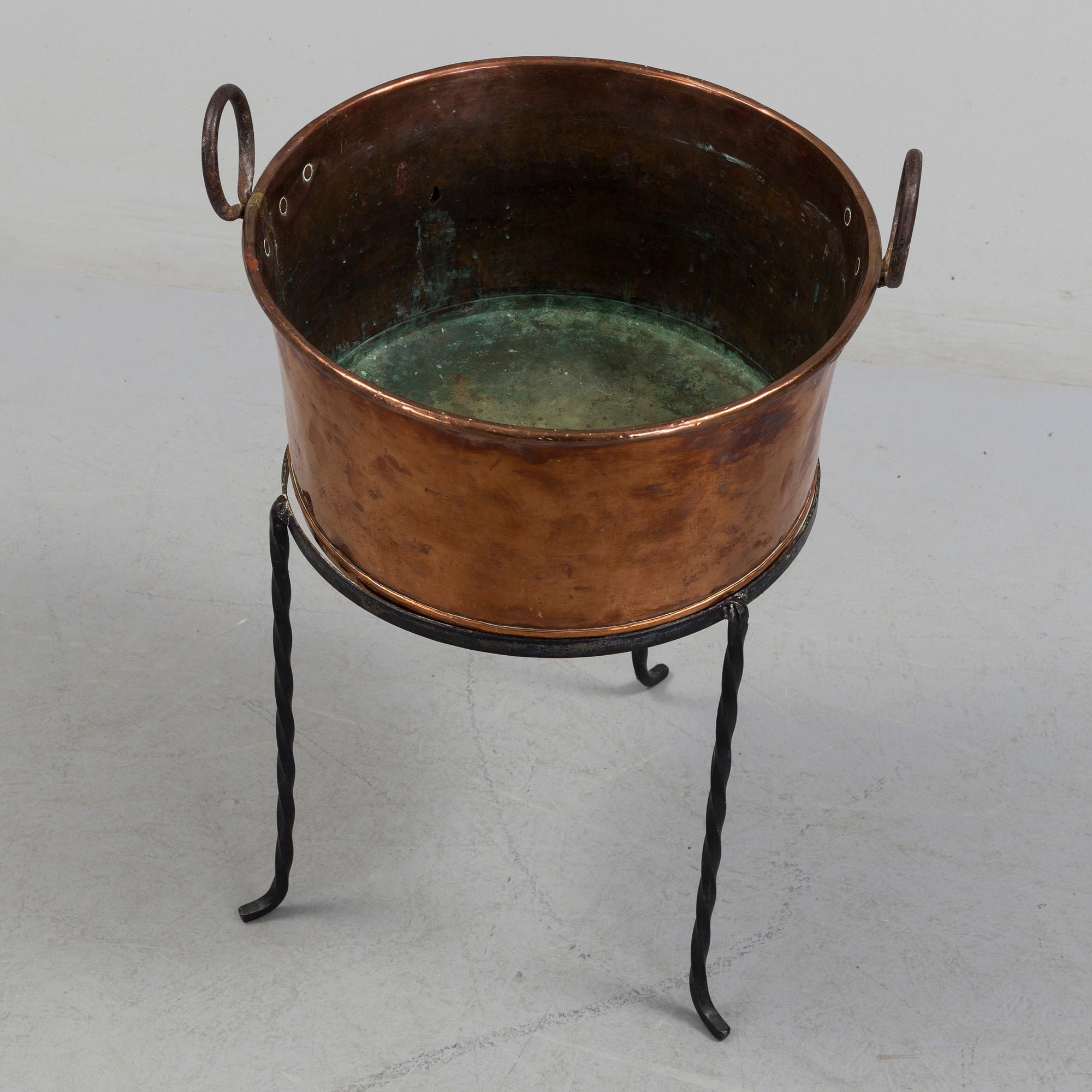 A 19th century copper cauldron.