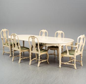 A rococo style dining table, four chairs and a pair of armchairs.