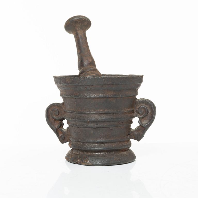 A cast-iron mortar and pestle of renaissance-type, 17th century.