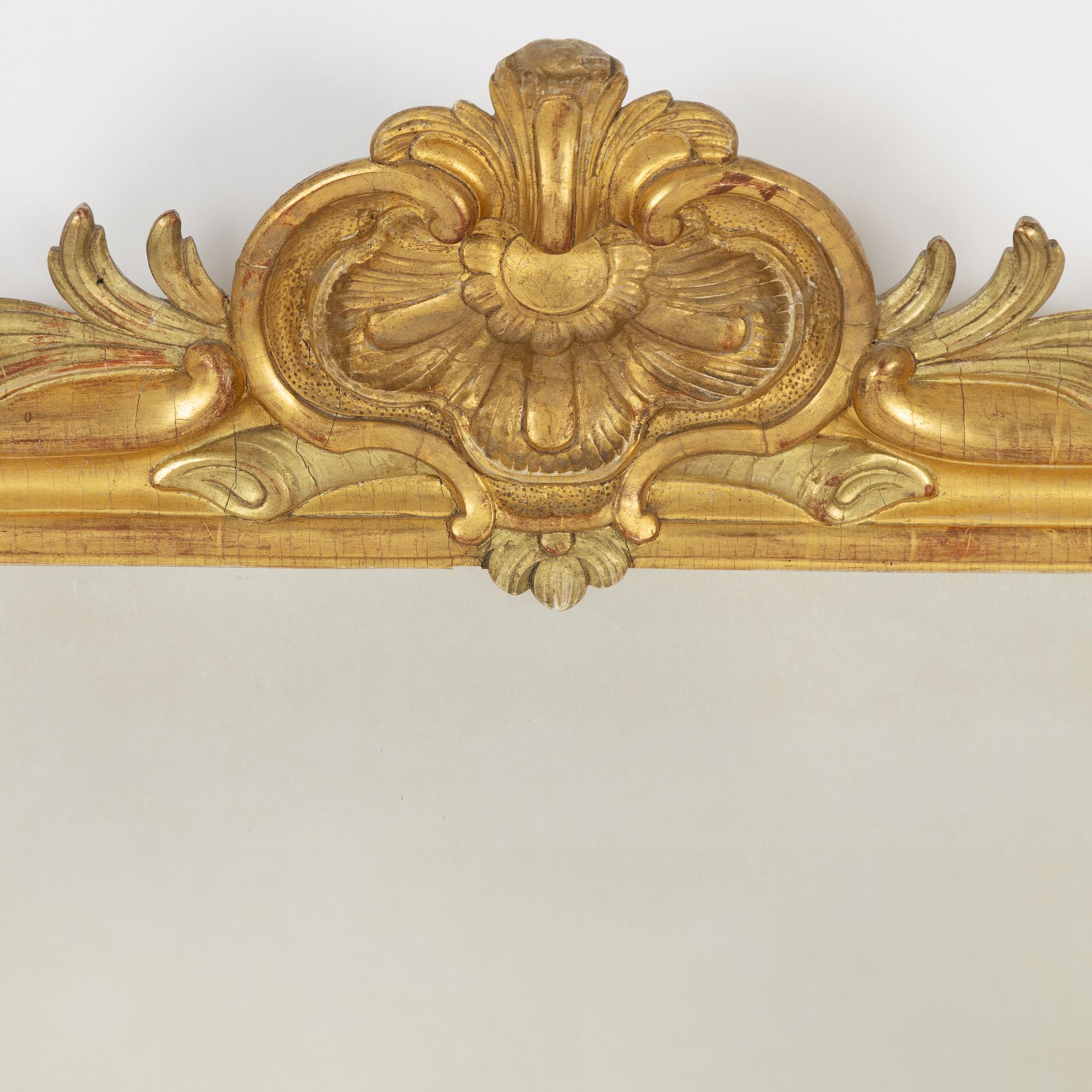 A Gustavian giltwood frame with mirror glass, Stockholm, late 18th century.