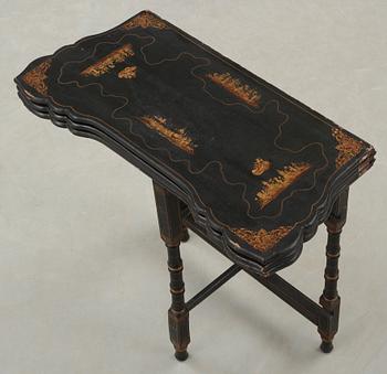 A black and gold laquered games table, 18-19th century.